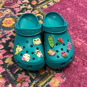 Teal Crocs (charms included but can be taken out)